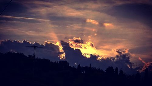 Silhouette trees against sky during sunset