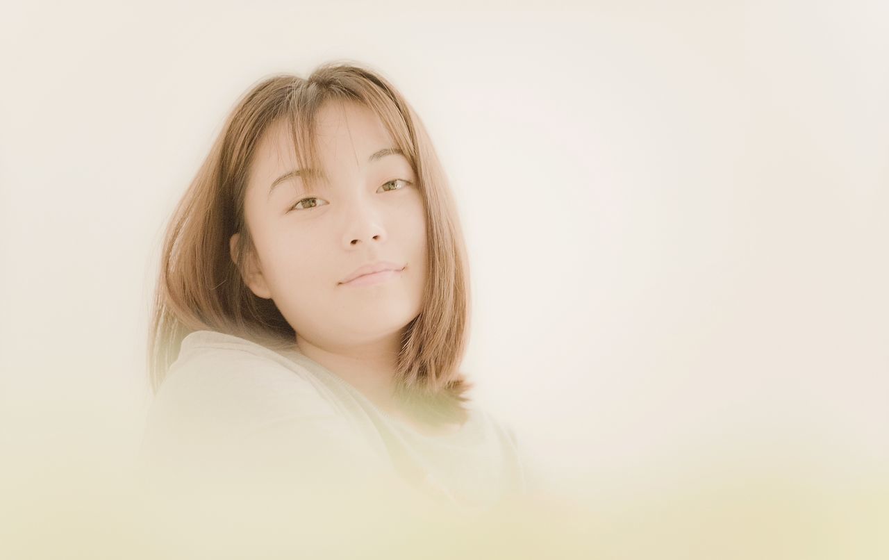 young adult, person, young women, lifestyles, white background, studio shot, portrait, looking at camera, headshot, long hair, front view, leisure activity, copy space, casual clothing, waist up, eyes closed, contemplation