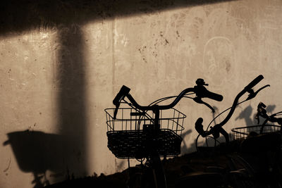 Silhouette people against wall