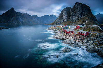 Scenic view of sea and mountains against sky