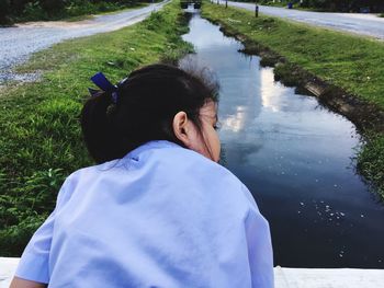 Rear view of girl looking at canal