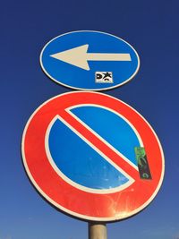 Low angle view of sign board against sky