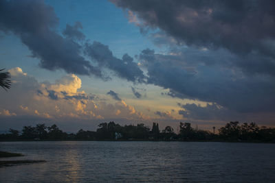 Scenic view of lake against sky at sunset