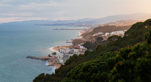 High angle view of buildings by sea against sky