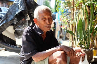 Portrait of senior man sitting outdoors