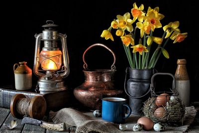 Close-up of vase on table against black background