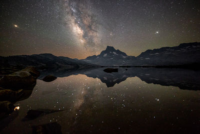 Scenic view of lake against sky at night