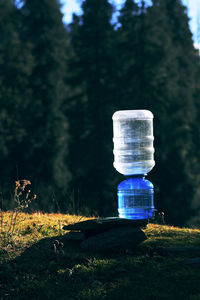 Close-up of water bottle on field