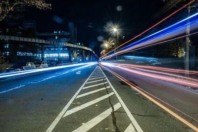 Light trails on road in city at night