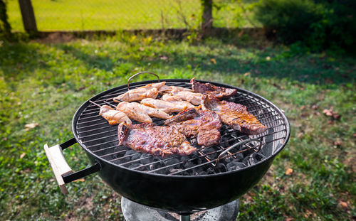 Close-up of meat on barbecue grill in yard