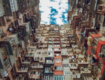 Low angle view of buildings in town against sky