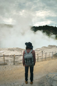 Full length of man standing on land against sky