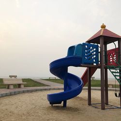 Lifeguard hut on playground against sky