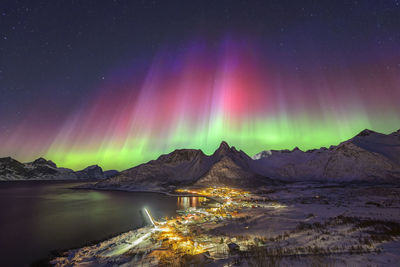 Norway, troms og finnmark, mefjordvaer, northern lights over remote fishing village on senja island