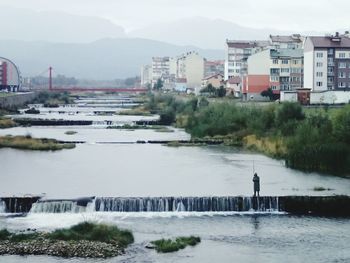 Pier over river against sky