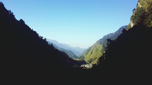 Scenic view of mountains against clear blue sky