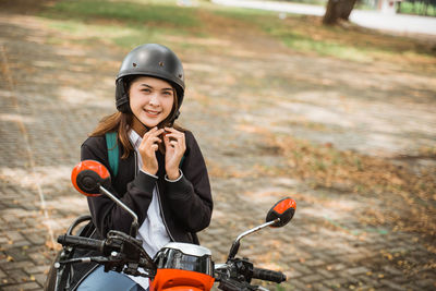 Side view of man riding motorcycle on road