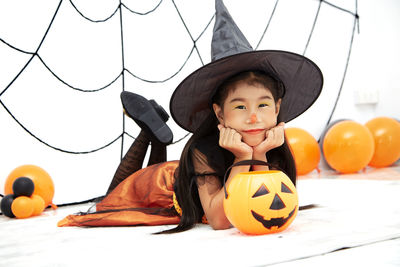 Full length of a boy with pumpkins