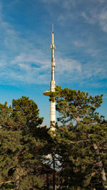 Low angle view of communications tower against sky