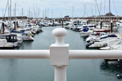 Close-up of sailboats moored at harbor