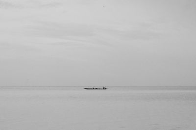 Boat sailing in sea against sky