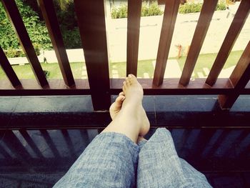 Low section of woman relaxing on bench