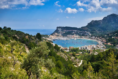 Panoramic view of city by sea against sky