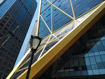 Low angle view of modern glass building in city