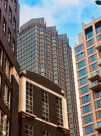 Low angle view of modern buildings in city against sky