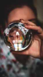 Cropped hand holding crystal ball