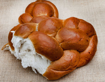 Challah or braided bread on rustic surface