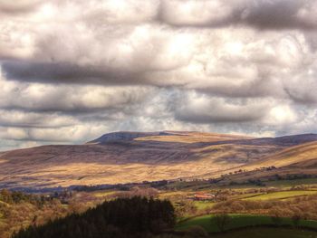 Scenic view of landscape against cloudy sky