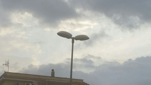 Low angle view of telephone pole against sky