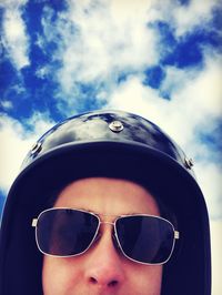Close-up portrait of mid adult man against sky