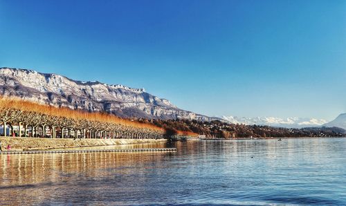 Scenic view of lake against clear blue sky