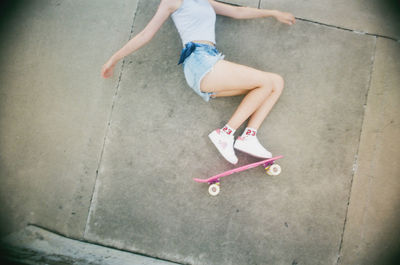 Low section of girl skateboarding on skateboard