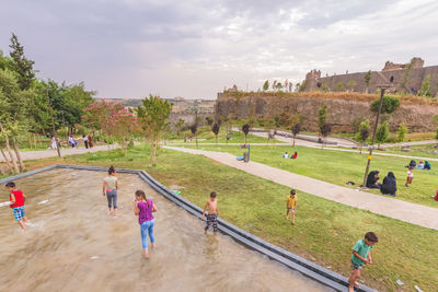 High angle view of people playing soccer against sky