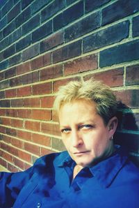Portrait of teenage boy against wall