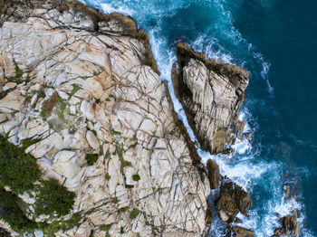 High angle view of rocks by sea