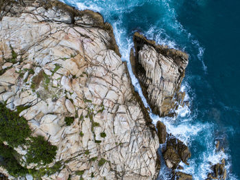 High angle view of rocks by the sea