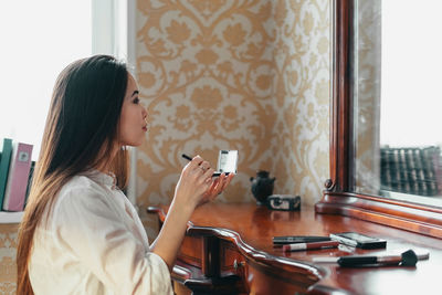 Side view of woman using smart phone