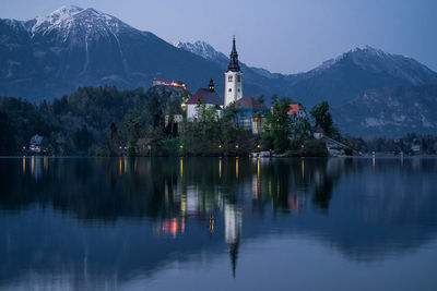 Reflection of trees and buildings in lake