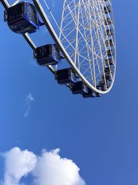 Low angle view of ferris wheel against blue sky