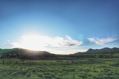 Scenic view of field and mountains against sky