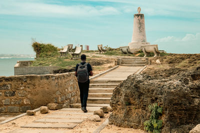 Rear view of a man standing at the vasco da gama pillar - a history monument in malindi, kenya