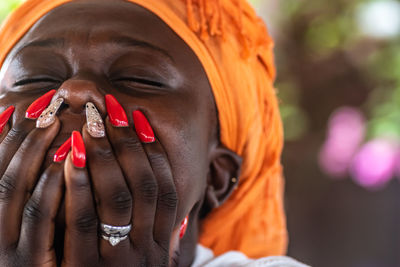 Close-up portrait of woman with hands