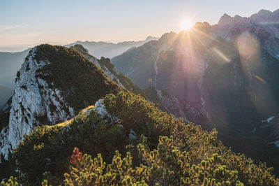 Scenic view of mountains against bright sun