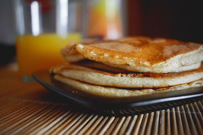 Close-up of pancakes in plate on table