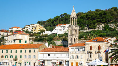 Buildings in town against sky