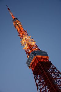 Low angle view of illuminated tokyo tower against clear sky at dusk